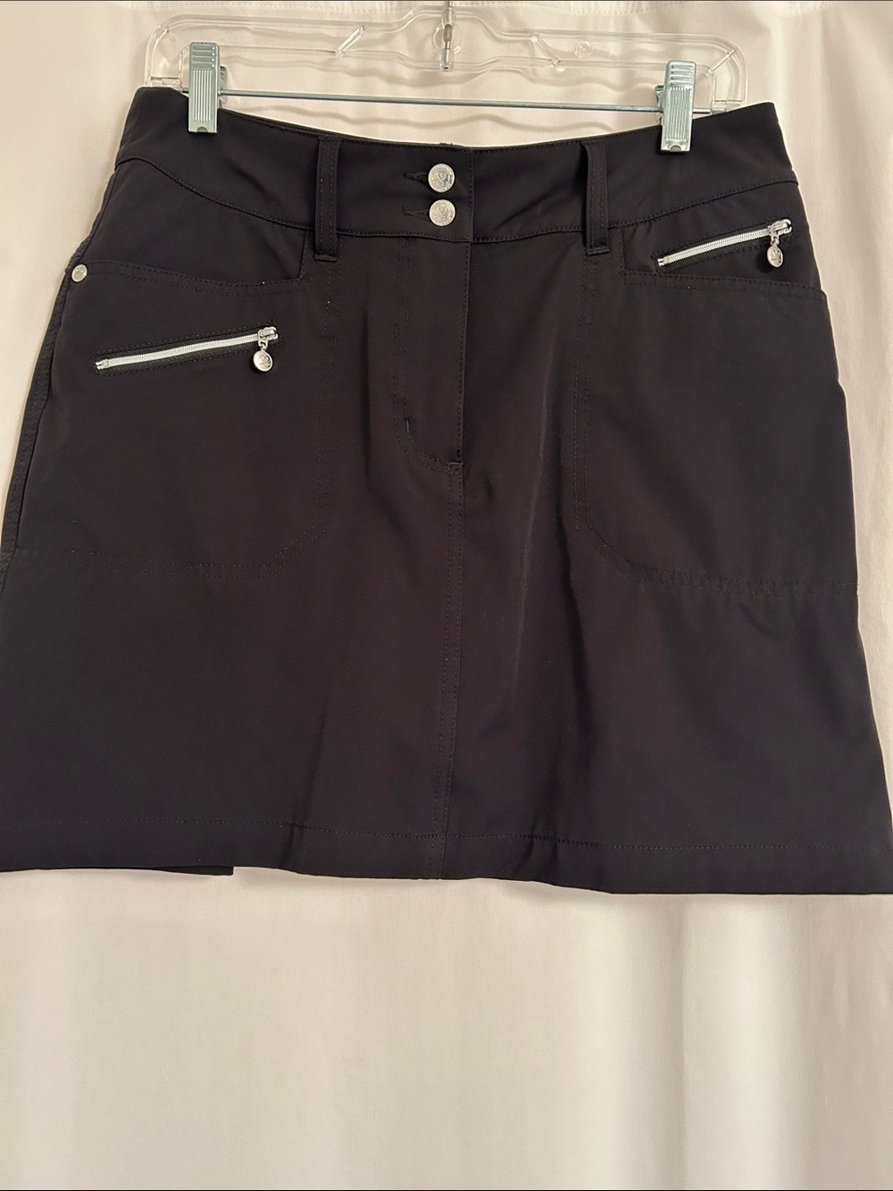 Daily Sports Black Active Skort with Silver Zippers and Buttons.